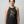 Woman wearing historical Cleopatra weightlifting graphic beautifully printed on soft, heathered charcoal tri-blend fabric with a clean, curved hemline.