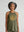 Woman with grey streaked hair wearing a green vintage not fragile halter tank top 