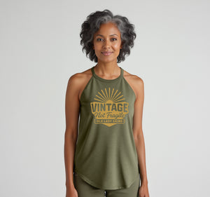 Woman with grey streaked hair wearing a green vintage not fragile halter tank top 