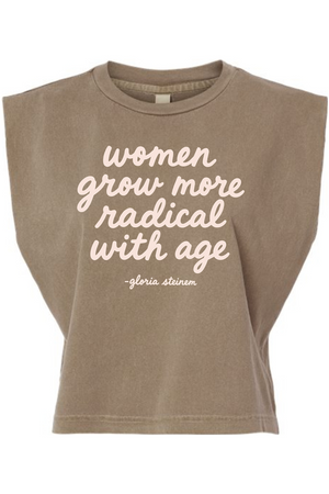 A cropped, sleeveless t-shirt in a washed taupe-brown color, featuring the quote 'women grow more radical with age - gloria steinem' printed in a light pink script font on the front.