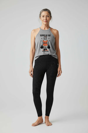 Vintage-style illustration of Mrs. Claus performing a farmer carry with two large kettlebells, wearing a red suit and confident grin, under the text ‘Yippee Ki Yay’ on an Old Lady Gains women’s halter tank.