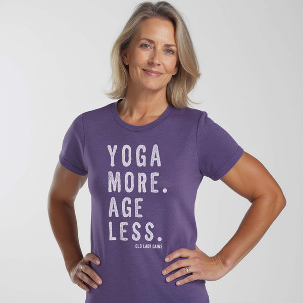 Women’s triblend t-shirt with the phrase “Yoga More. Age Less.” designed for active women over 40 who prioritize mobility and strength.