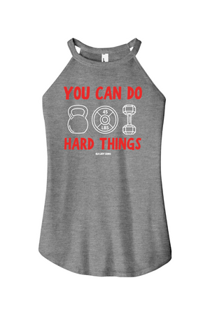 A heather gray racerback tank top featuring a red and white graphic print that reads 'YOU CAN DO HARD THINGS' with kettlebell, weight plate, and dumbbell illustrations.